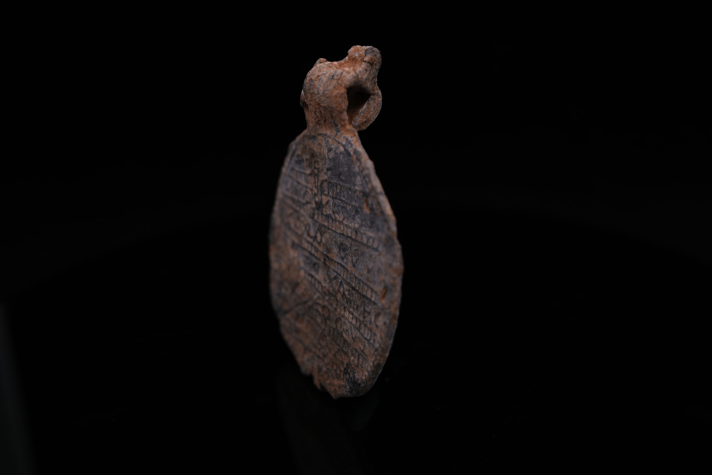 Lead amulet reverse with serpent motif